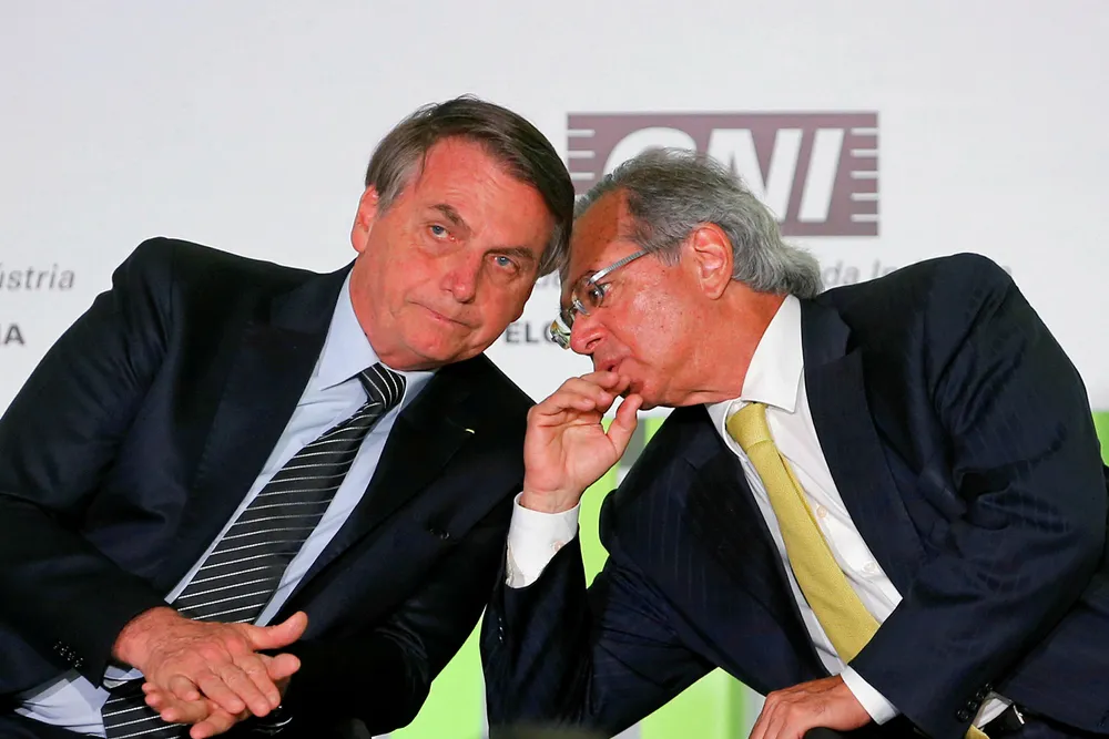 Scaling down: Brazilian President Jair Bolsonaro listens to Brazil's Economy Minister Paulo Guedes during a meeting