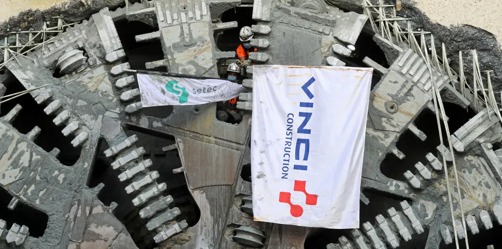 Workers of construction groups Vinci Construction and Setec wave flags after the arrival of tunnel boring machine "Ellen" at the construction site of the future Grand Paris Express railway station Fort d'Issy-Vanves-Clamart in Clamart, southwest of Paris.