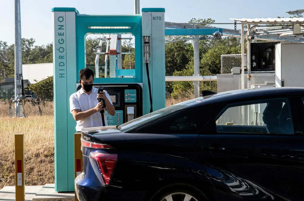 A man filling his Toyota Mirai hydrogen car at a refuelling station in Costa Rica.