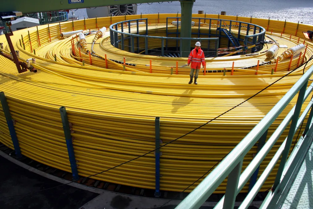 Subsea umbilicals on a spool, ready to be reeled onto a pipelay vessel.