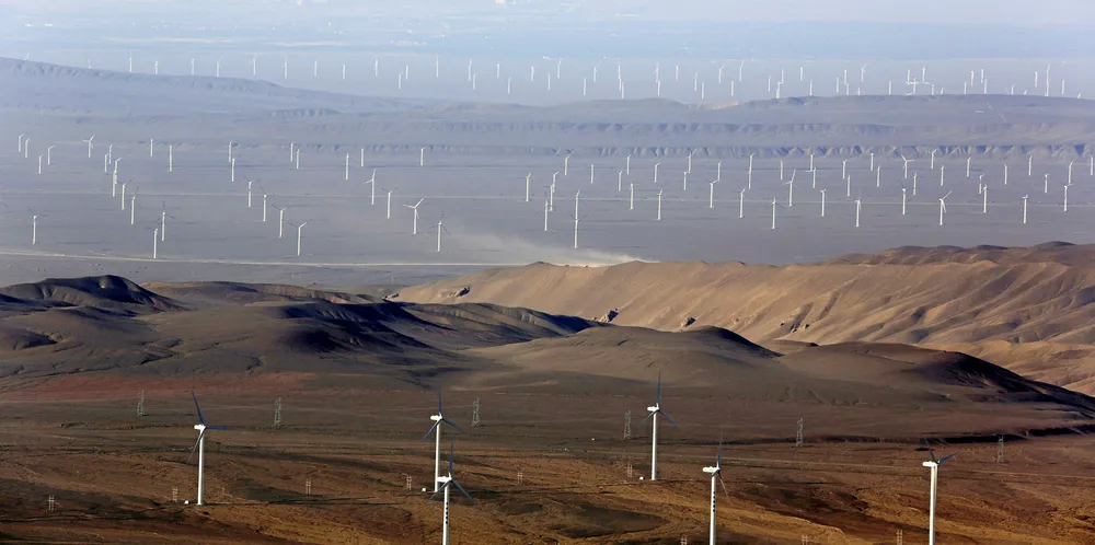 Hundreds of wind turbines sit in the Turfan Depression in China's northwestern Xinjiang on July 18, 2016. / AFP / PATRICK BAZ (Photo credit should read PATRICK BAZ/AFP/Getty Images) China 403GW wind. China wind turbines.