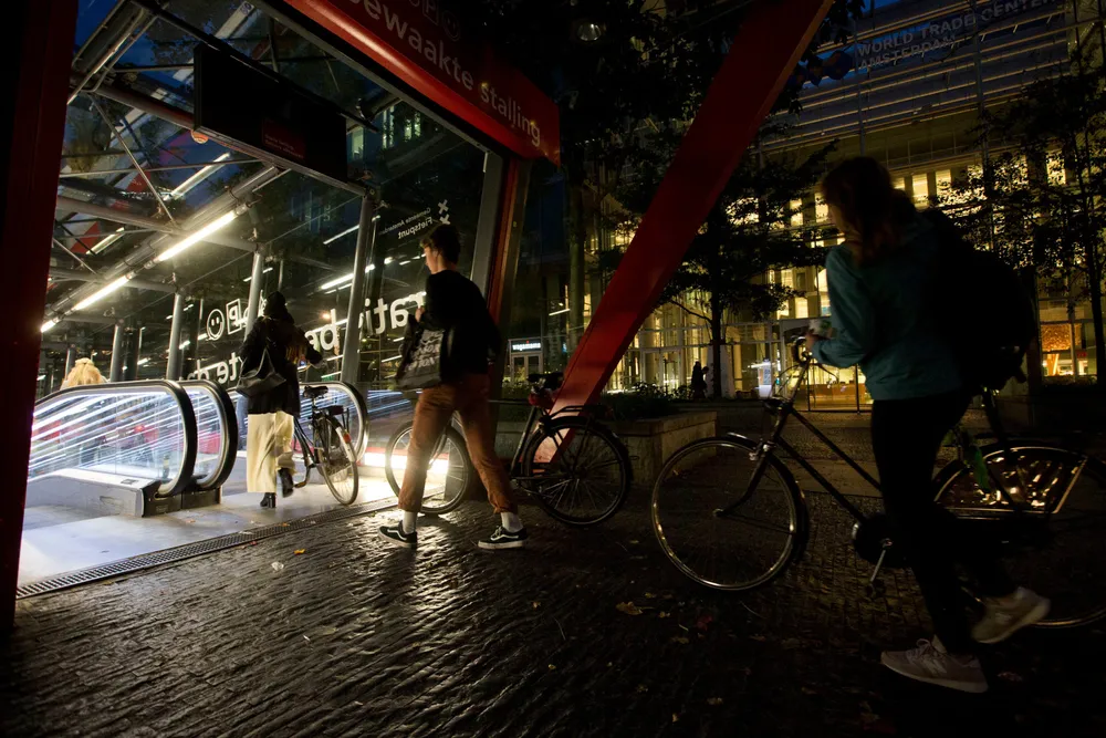 Green line: commuters queue to enter an Amsterdam metro station, where advertising for fossil-fuel products has been prohibited
