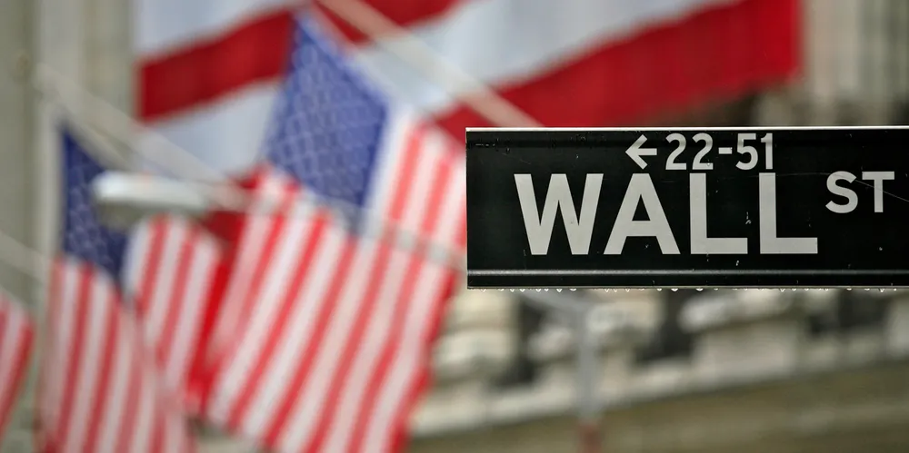 Rain drips from the Wall Street sign outside the New York Stock Exchange. The NYSE is one of the city's two stock markets.