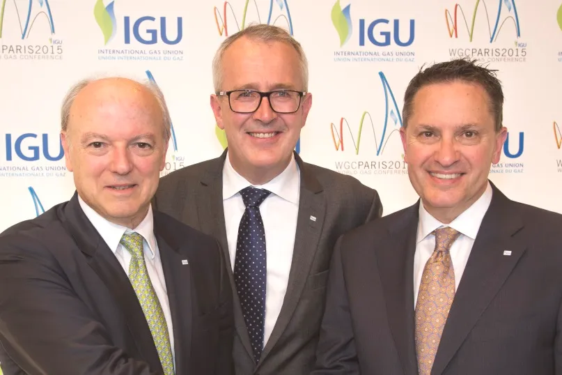 Handing off: Jerome Ferrier (left) hands off IGU presidency to David Carroll (right) as secretary-general Paal Rasmussen stands centre