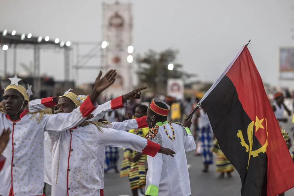 A reveller carries an Angolan flag in the Luanda Carnival in March 2025.