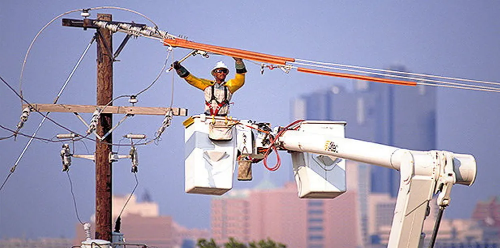 Oncor technician works on an overhead powerline