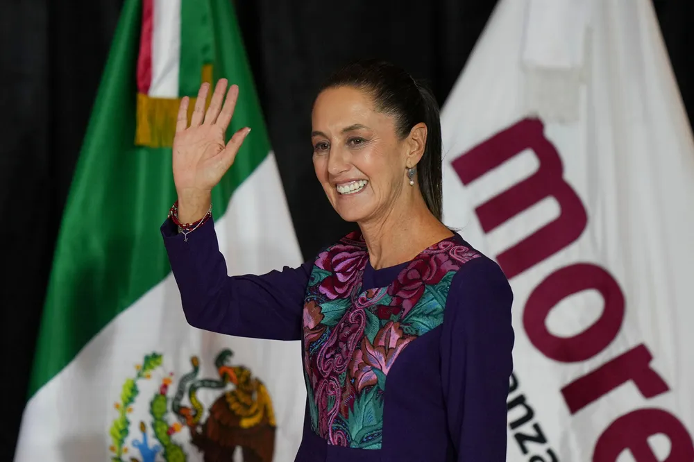Ruling party presidential candidate Claudia Sheinbaum greets supporters after the National Electoral Institute announced she held an irreversible lead in the election in Mexico City, early Monday, 3 June 2024.
