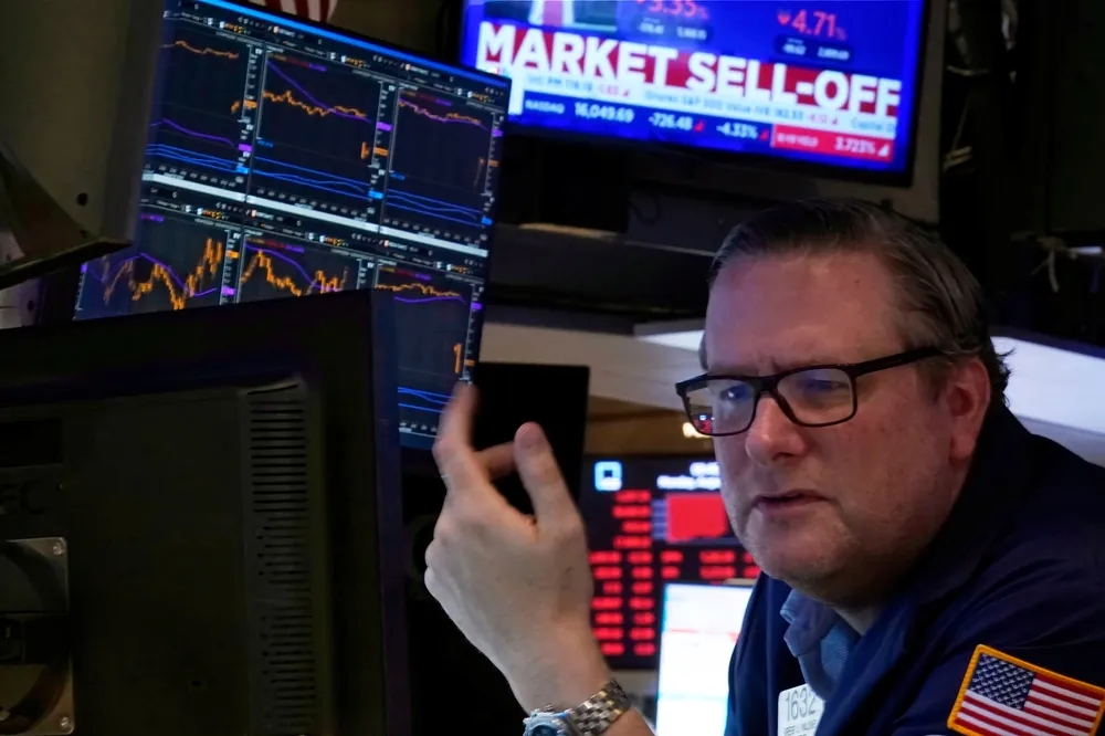 Specialist Gregg Maloney works at his post on the floor of the New York Stock Exchange on Monday, 5 August 2024. Nearly everything on Wall Street is tumbling as fear about a slowing US economy worsens and sets off another sell-off for financial markets around the world.