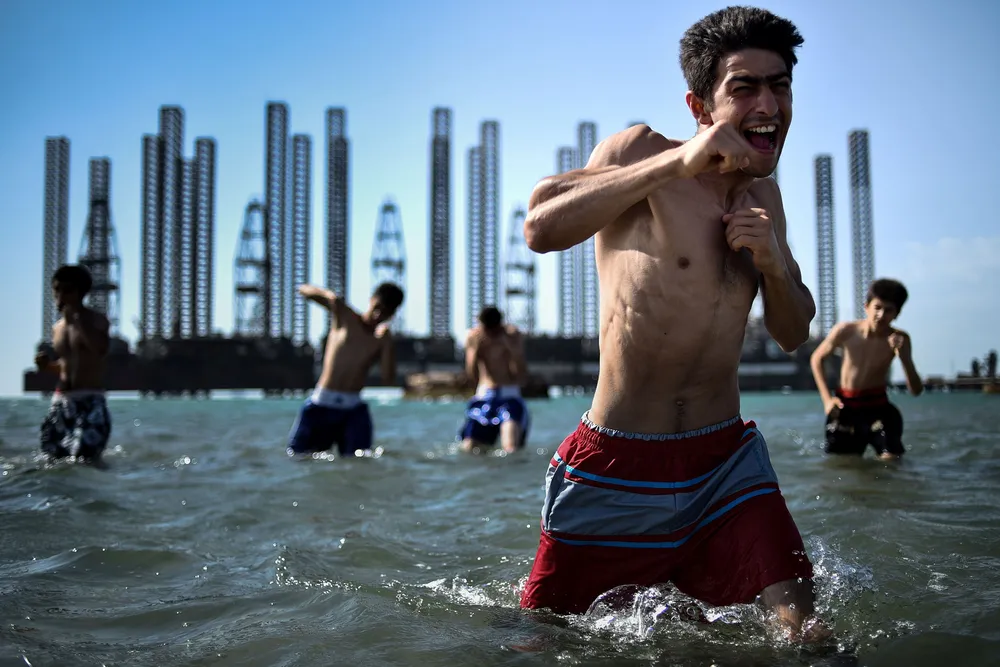 Bring it on: teenagers from a boxing school take part in a training session in the Caspian Sea near Soviet-era oil rigs in Baku, Azerbaijan