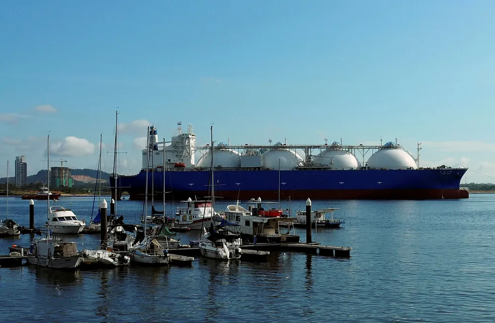 Imports: an LNG tanker passes boats along the coast of Singapore