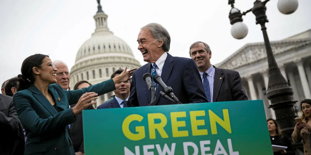 Senator Edward Markey, who is backing the legislation, greets Representative Alexandria Ocasio-Cortez, a fellow Democrat from New York.