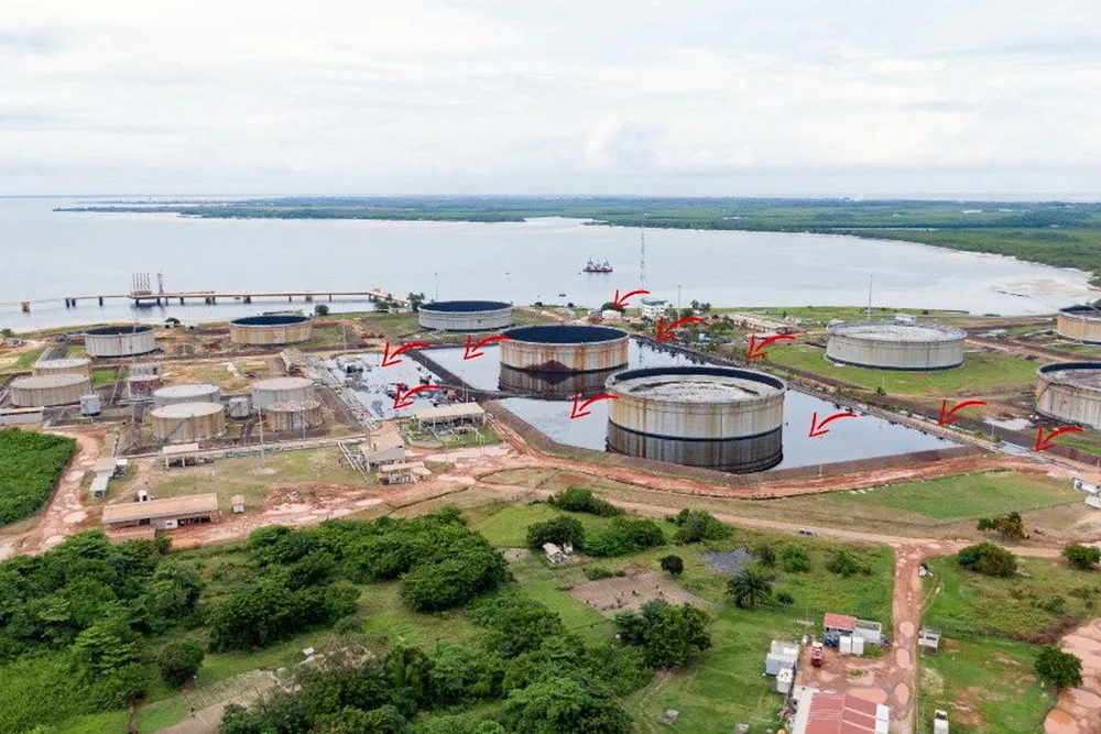 Major oil leak: an oil spill from a Perenco-operated storage tank at Cap Lopez has so far been mostly contained by retainment berms - red arrows indicate extent of spill