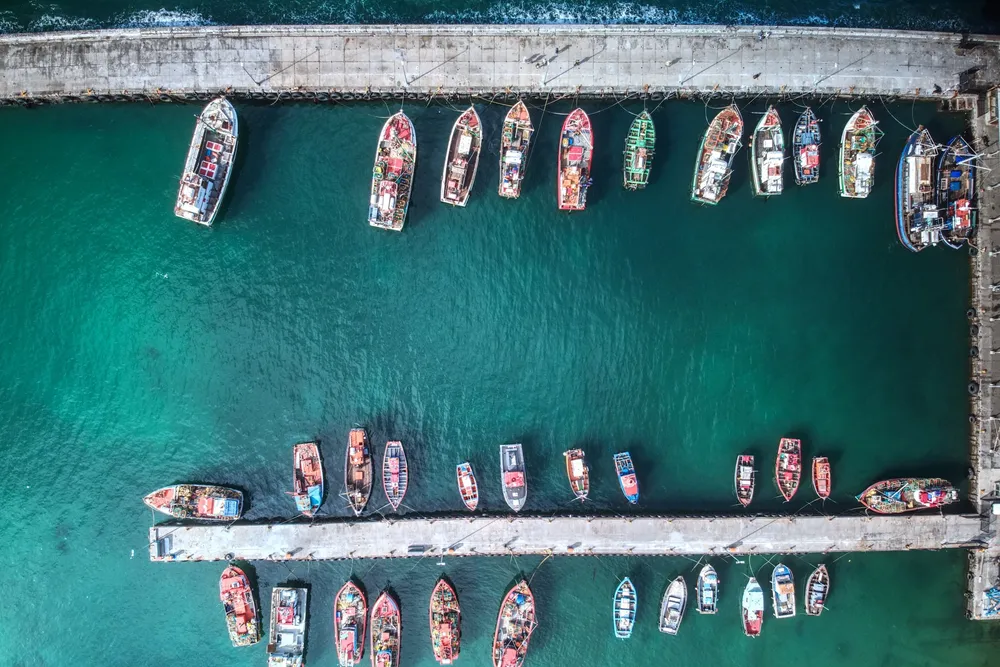 An aerial shot of fishing boats near Cape Town, South Africa. Community Catch conducted one of five "beta trials" at a small-scale fishery in South Africa. The others took place in Indonesia, Mexico and two locations in Scotland.