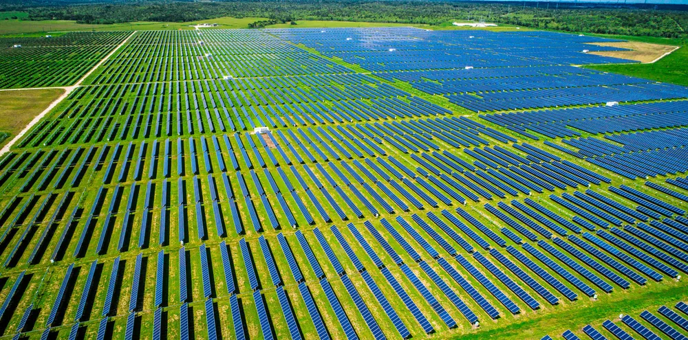 Aerial drone view above thousands of PV panels making up a Texas solar plant