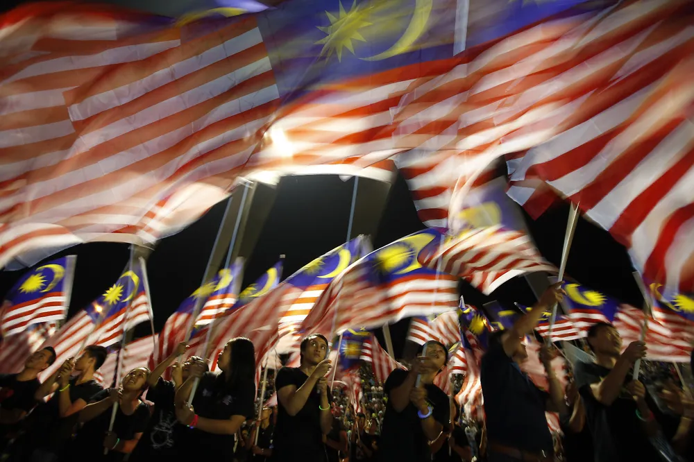 Onshore win: locals from Sabah wave Malaysian flags