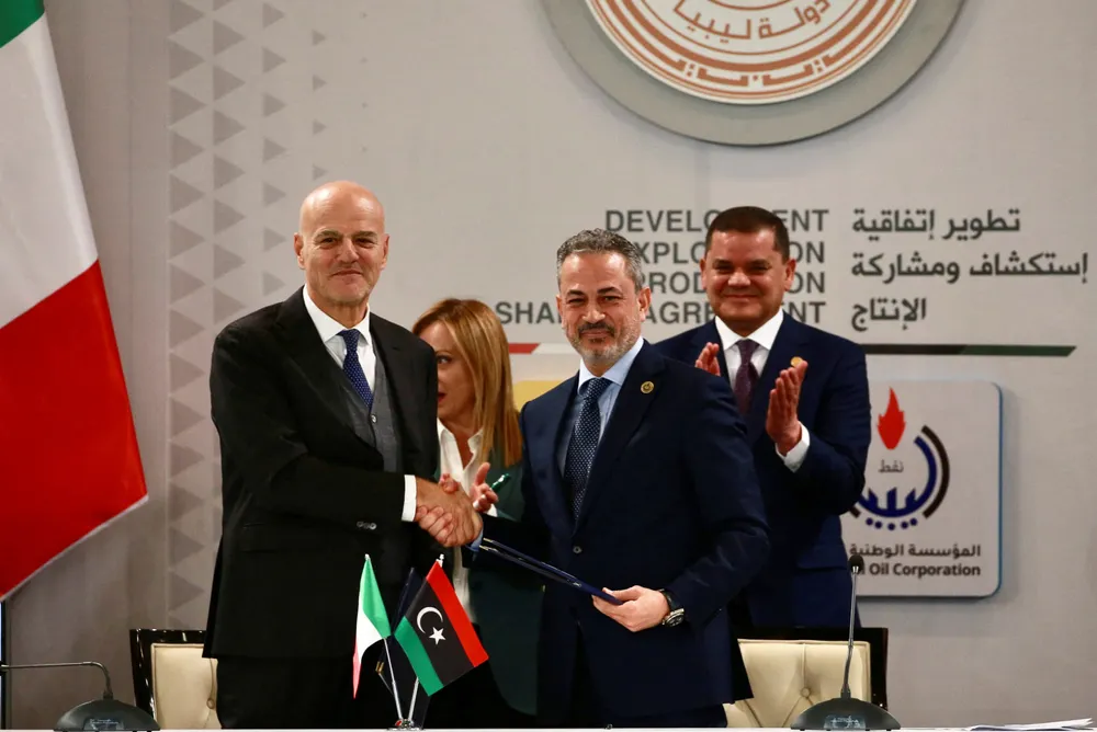 Eni chief executive Officer Claudio Descalzi (left), and Farhat Bengdara, head of Libyan state oil company, shjake hands in Tripoli, Libya in 2023.