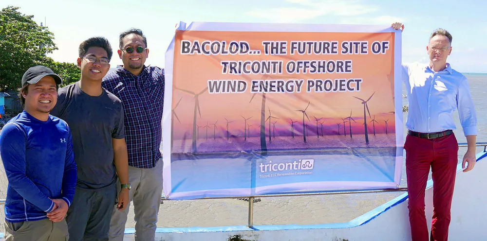 Theo Sunico, holding banner (left), with Stefan Simon, managing director of Steam Invest (right).