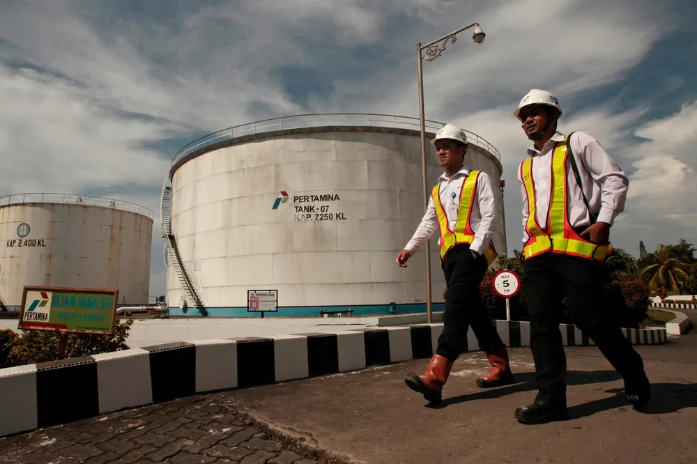 Employees of Indonesia's national oil company Pertamina walk through the main storage depot in Makassar, South Sulawesi province.