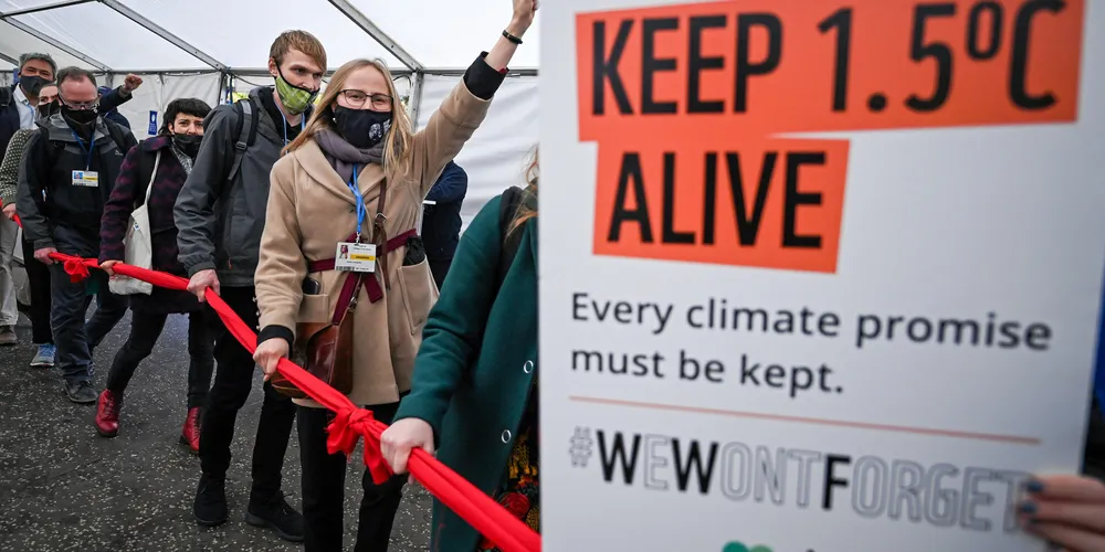 Protesters move through restricted Blue Zone area of COP26 climate summit.