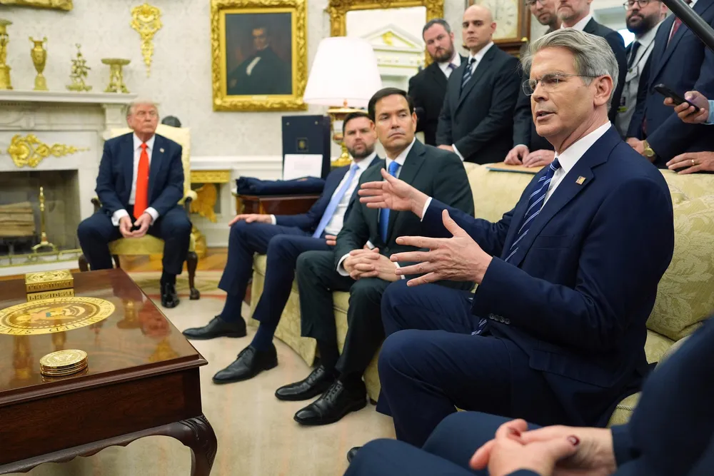 Treasury Secretary Scott Bessent, right, speaks in the White House.