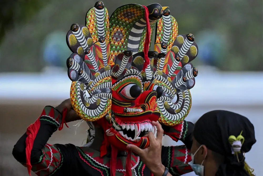 Celebration: a traditional dancer prepares to perform during the Esala Perahera festival in front of the historic Ruhunu Maha Kataragama Hindu temple in Sri Lanka