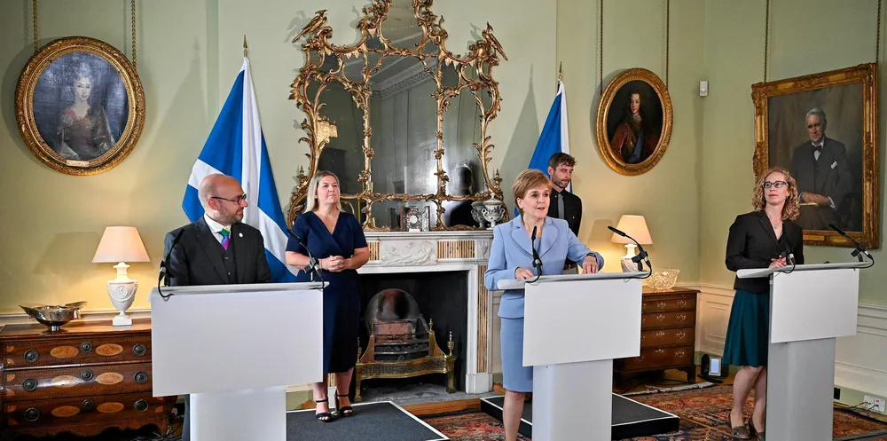 Scotland's First Minister and leader of the Scottish National Party (SNP), Nicola Sturgeon (C), holds a media briefing with Scottish Greens co-leaders Patrick Harvie (L) and Lorna Slater (R).