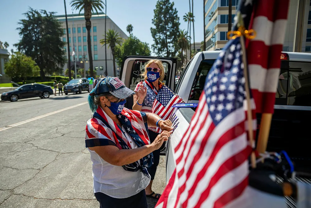 De frivillige Shelley Colman (til høyre) og Joanne Burdet dekorerer bilen for demokratenes presidentkandidat Joe Biden. Fra Riverside i California ringer de nesten daglig til velgere i den viktige vippestaten Texas, og er bekymret for utfallet av valget.