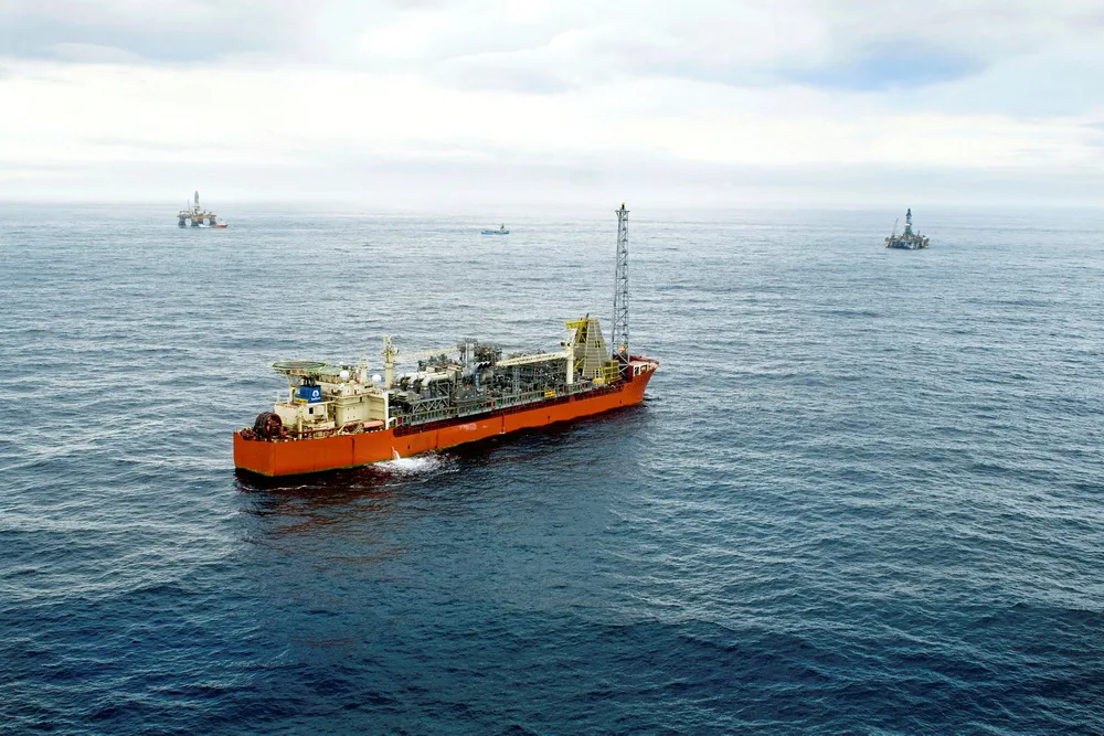 SeaRose FPSO with two rigs and a supply vessel in the background at Husky Energy's White Rose field off eastern Canada