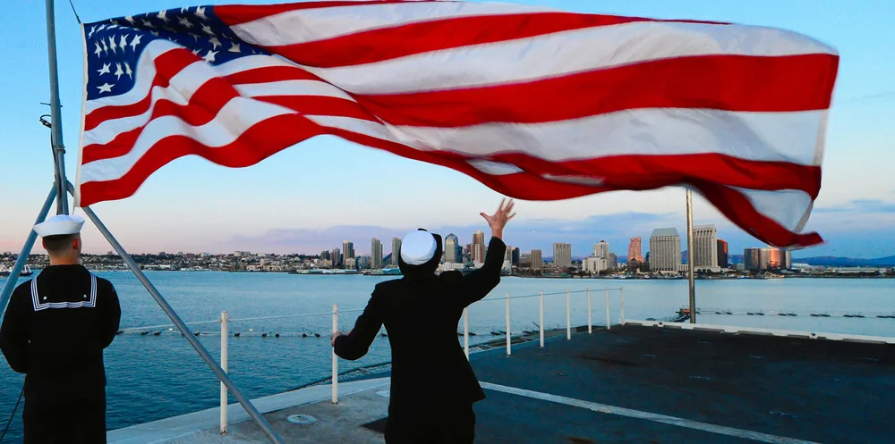 Lowing of the US flag aboard the aircraft carrier USS Ronald Reagan off California