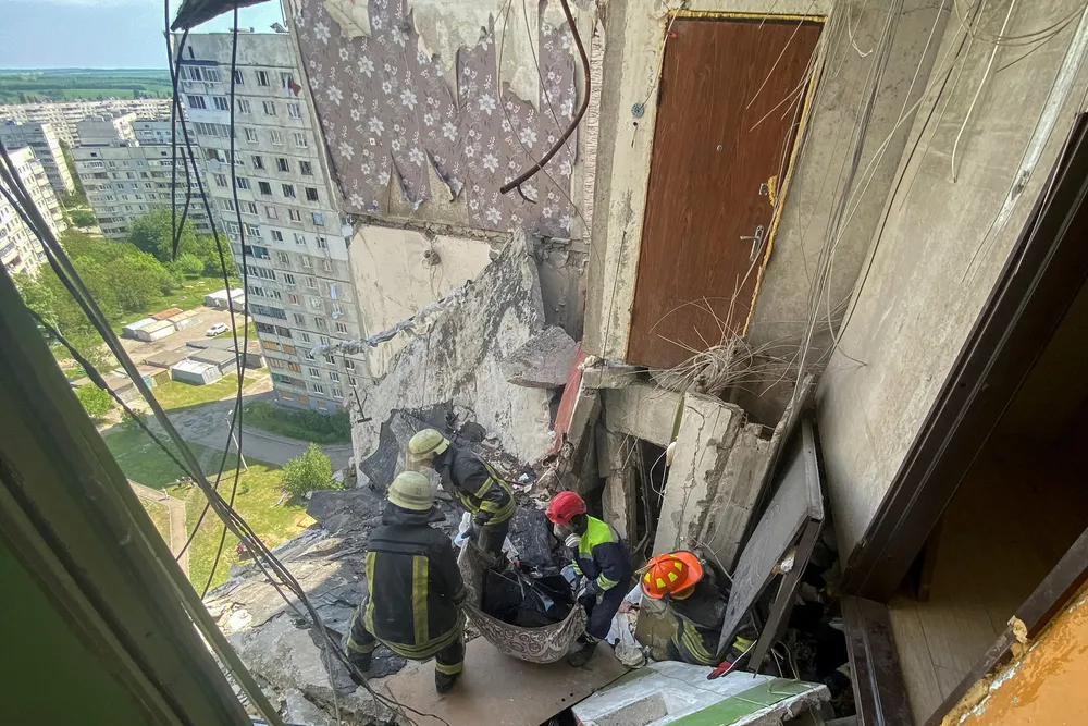 Broken: rescuers carry the body of civilian from a residential building damaged by shelling of Kharkiv in Ukraine