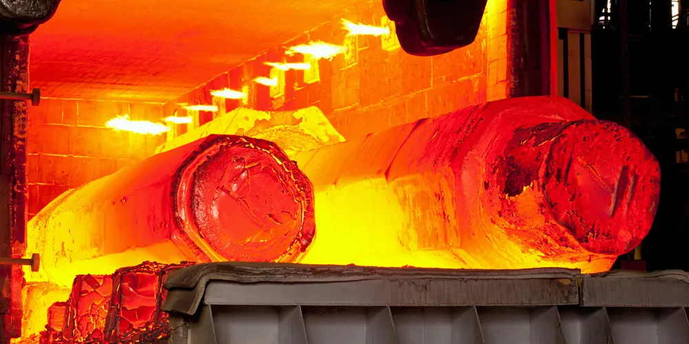 Two hot molten forged steel rods in a furnace.