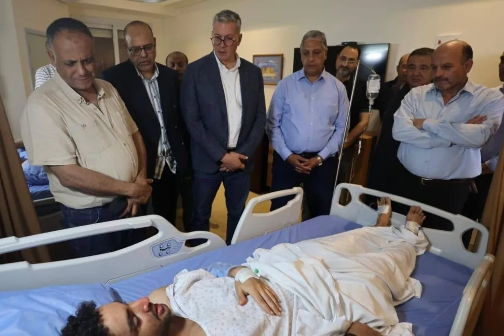 Egyptian government officials — including Petroleum Minister Karim Badawi (third from left) — visit a survivor of a fatal incident in the Red Sea where a drilling barge capsized.