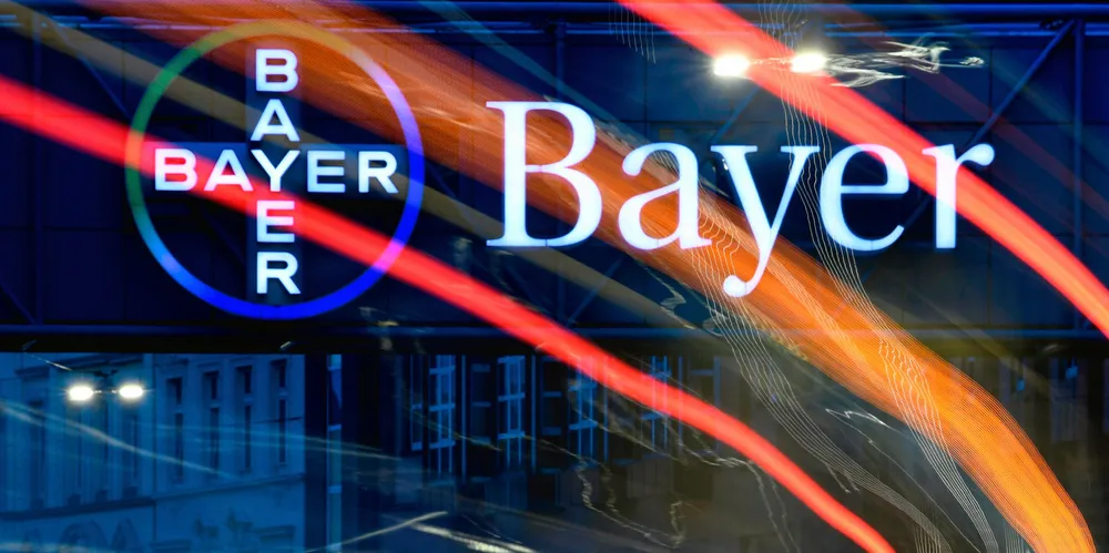 A picture taken with a long exposure on April 23, 2019 shows the lights of a bus and cars in front of the logo of German chemicals and pharmaceuticals giant Bayer at the group's plant in Wuppertal, western Germany.