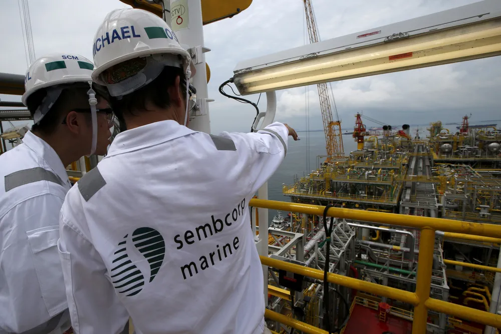 Earlier days: Sembcorp Marine workers look at the modules on main deck of Tullow Oil's floating production, storage and offloading vessel Prof. John Evans Atta Mills