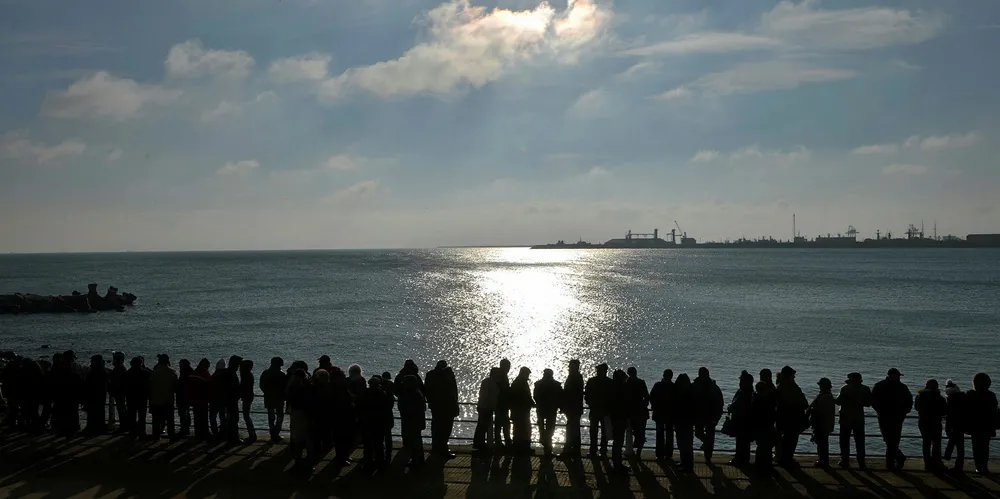 Romanians wait prior to a epiphany religious service in Constanta on the Black Sea.