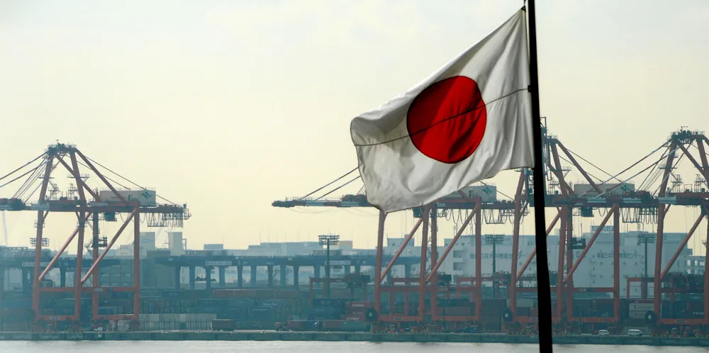 The Japanese national flag flies in front of the container pier in Tokyo port.