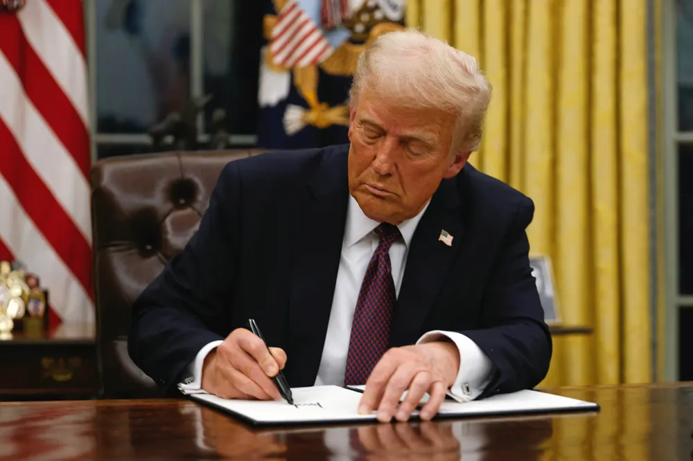 US President Donald Trump signs an executive order on 20 January 2025.