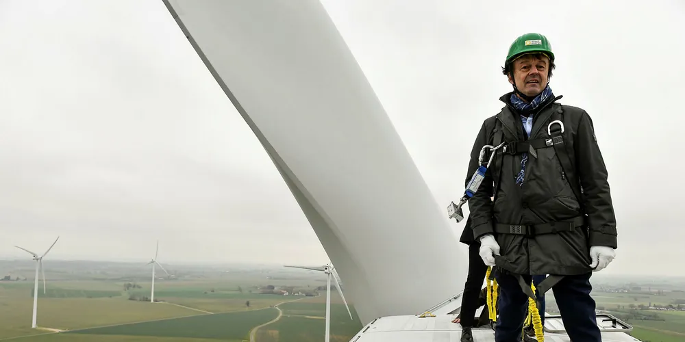 French ecology and transition minister Nicolas Hulot stands on top of a wind turbine during a visit of a wind farm in Juille.