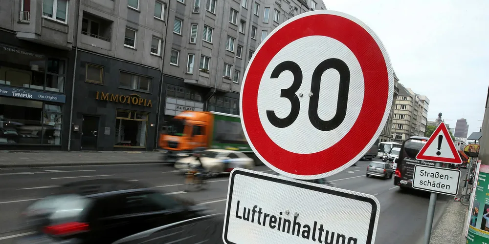 Cars drive past a sign that reads "Air purity control" on a test section of Leipziger Strasse street in Berlin. Germany's transport sector has not moved fast enough on emissions reduction.