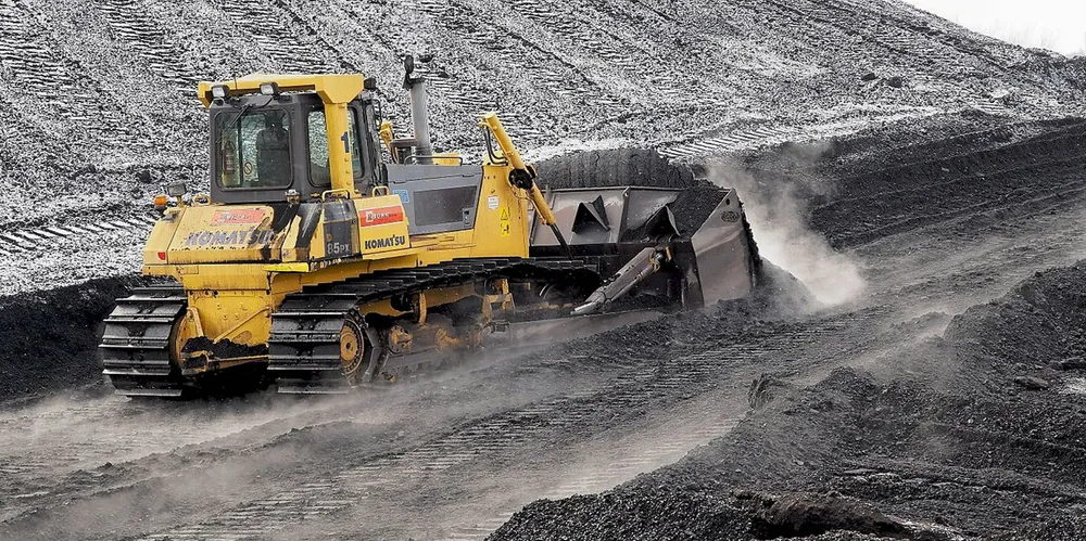 A bulldozer pushes coal at an Australian coal mine. China Energy has placed an order for Australian coal, according to Reuters.