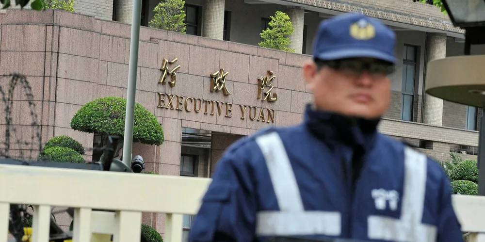A police officer stands guard in front of the Executive Yuan building in Taipei.