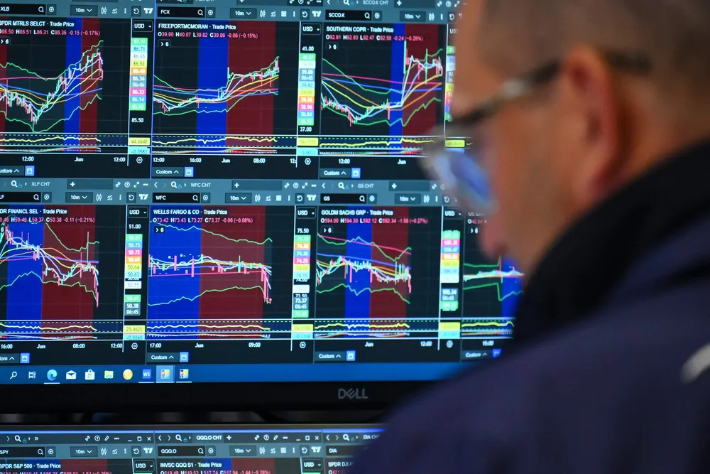 A trader works on the floor of the New York Stock Exchange at the opening bell on Monday.