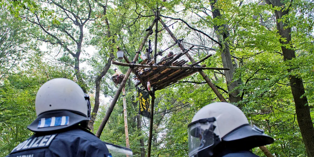 A tree house is seen behind police forces in Hambacher Forst forest during a protest against the expansion of an adjacent open-pit coal mine on September 13, 2018 near Julich, Germany.