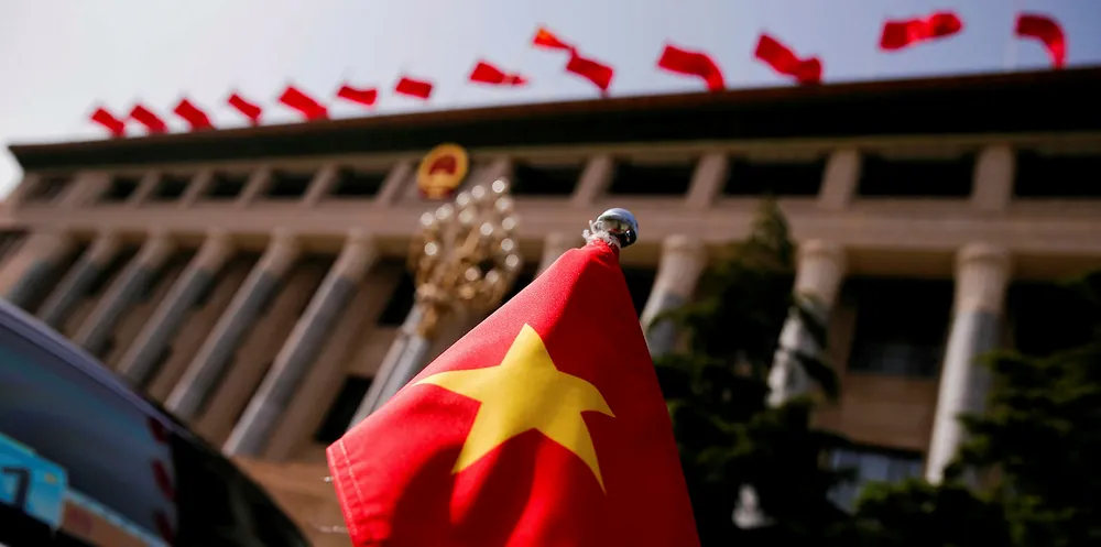 The Vietnamese national flag flies on a diplomatic car.