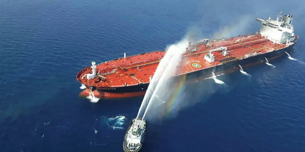 An Iranian navy boat tries to control a fire on the Norwegian-owned Front Altair, which was said to have been attacked in the waters off the Gulf of Oman