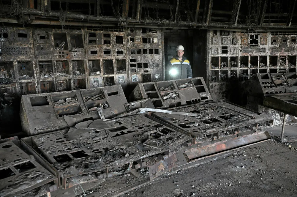 A worker walks through a burned out control room at a power plant of energy provider DTEK, destroyed after an attack, in an undisclosed location in Ukraine on April 19, 2024.