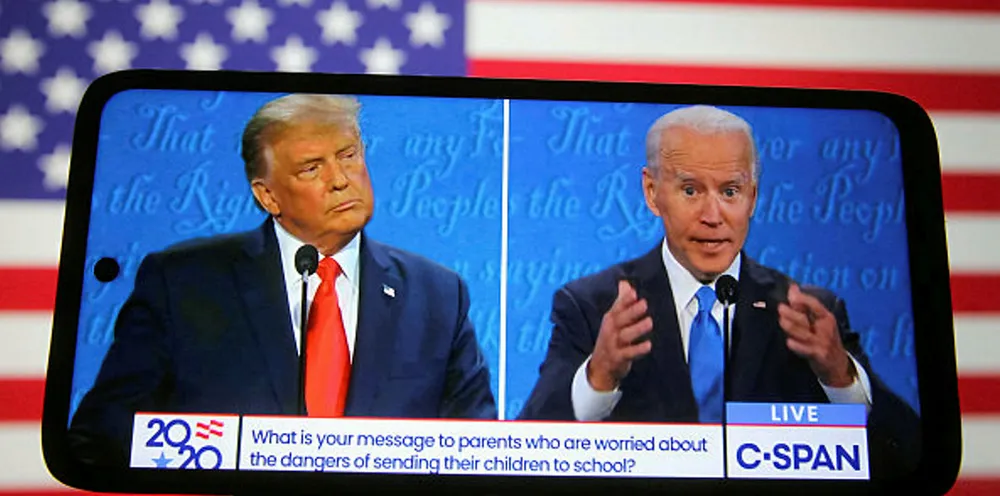 US President Donald Trump and Democratic presidential candidate and former US Vice President Joe Biden are seen during the final presidential debate displayed on a screen of a smartphone
