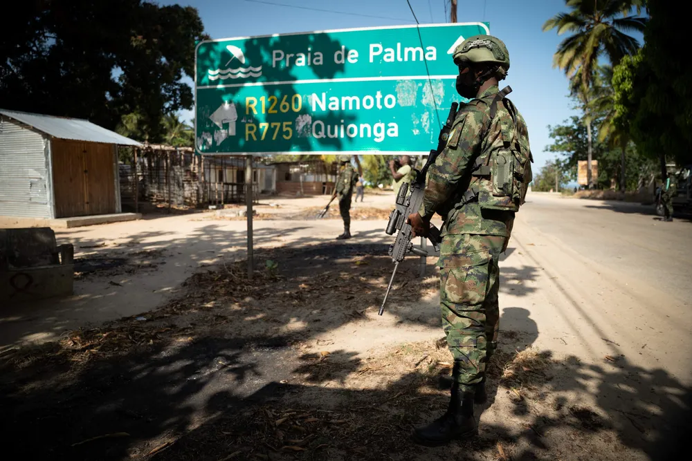 Calmer: a Rwandan soldier walks in front of a burned truck near Palma, Cabo Delgado, Mozambique in September, having forced insurgents out of the key coastal town