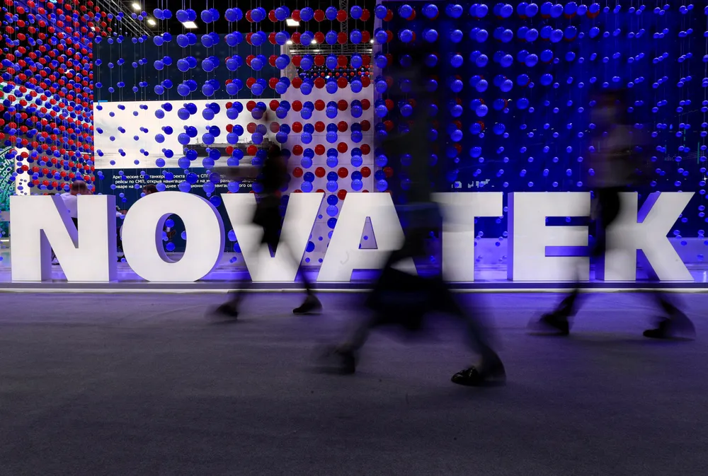 Moving forward: participants walk past an exhibition stand of Russian gas producer Novatek at St Petersburg International Economic Forum in June 2021