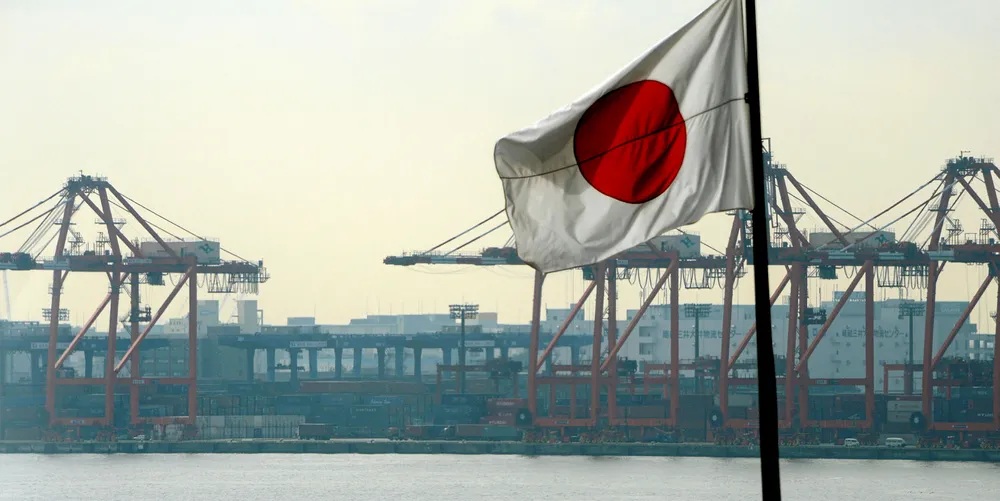 The Japanese national flag flies in front of the container pier in Tokyo port